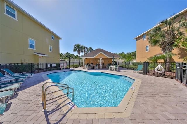 pool featuring a patio and fence