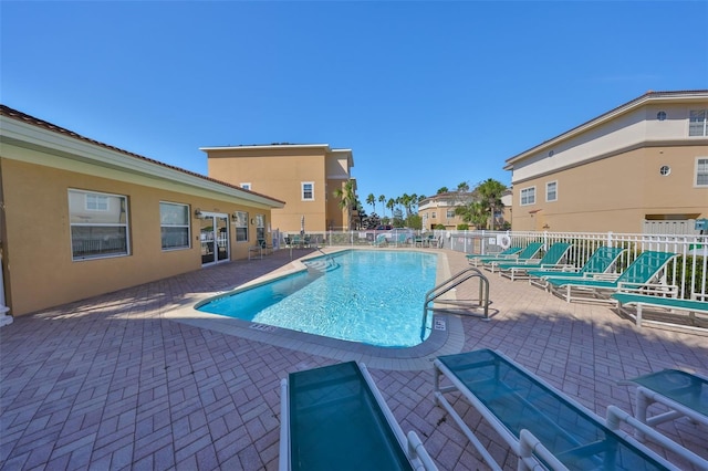 pool featuring a patio area and fence