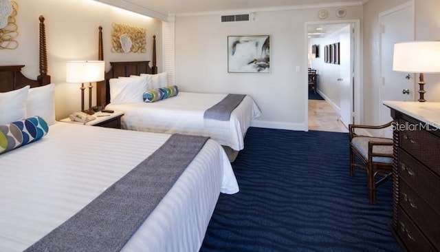 bedroom featuring baseboards, carpet, visible vents, and ornamental molding