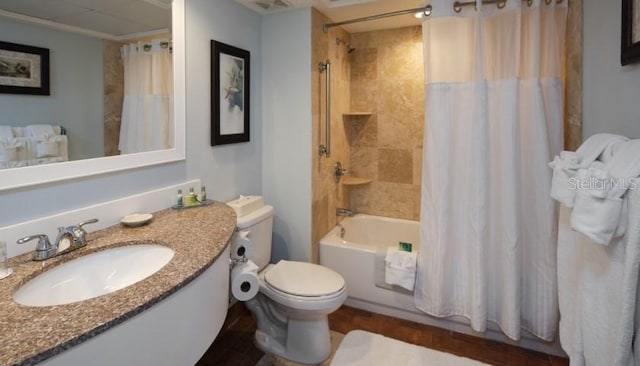 bathroom featuring shower / tub combo with curtain, vanity, and toilet