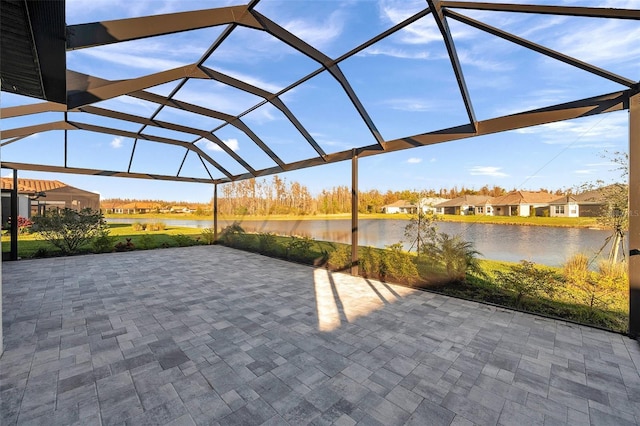 view of patio / terrace featuring a water view and a lanai