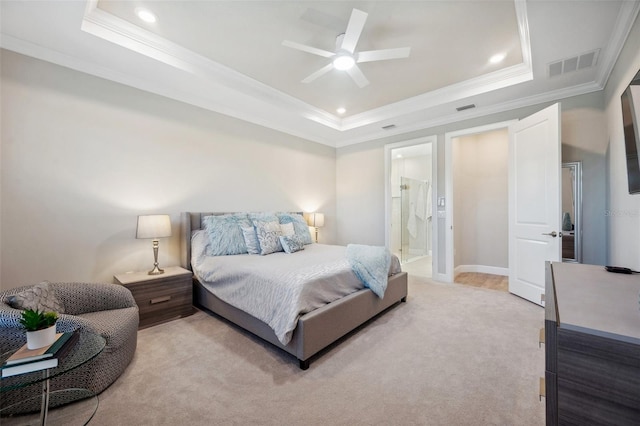 bedroom featuring visible vents, light colored carpet, a tray ceiling, and ornamental molding