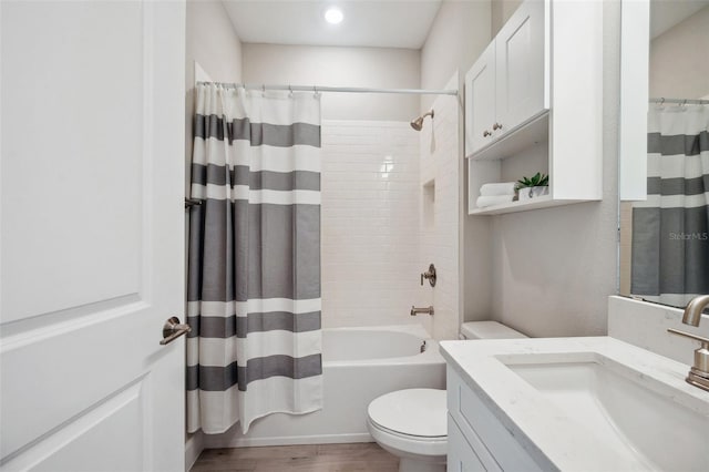 bathroom with vanity, toilet, shower / bath combo with shower curtain, and wood finished floors