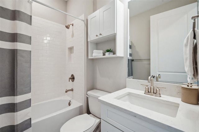 full bath featuring shower / bathtub combination with curtain, toilet, and vanity