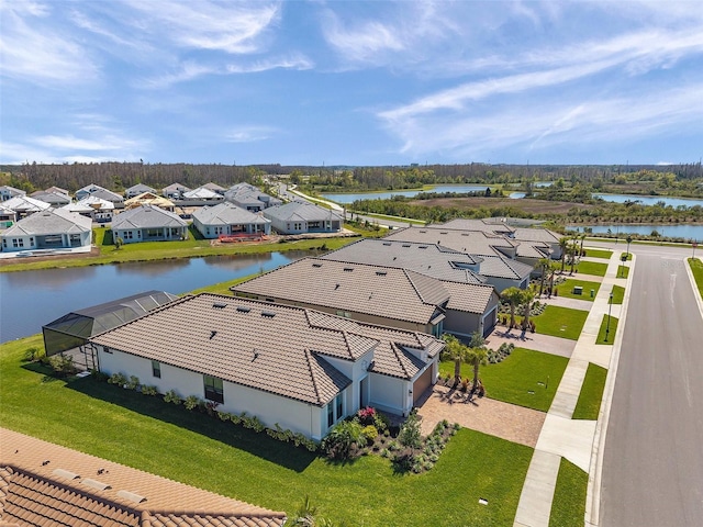 drone / aerial view featuring a residential view and a water view