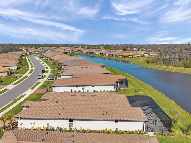 drone / aerial view featuring a residential view and a water view