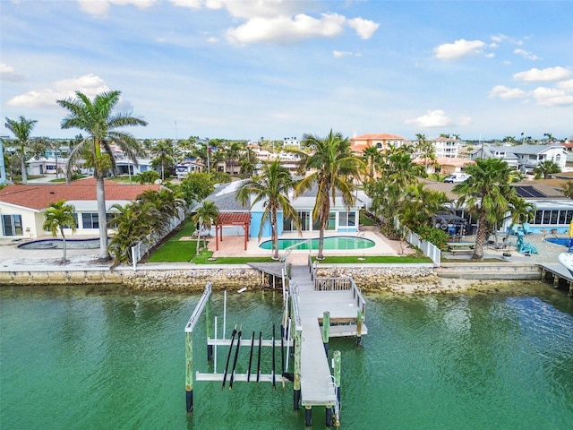 dock area with a patio area, boat lift, an outdoor pool, and a water view