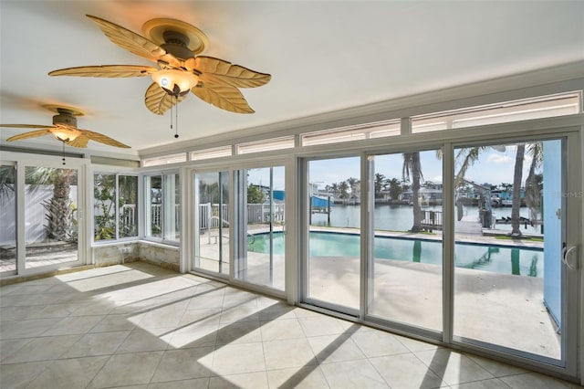 unfurnished sunroom with a water view