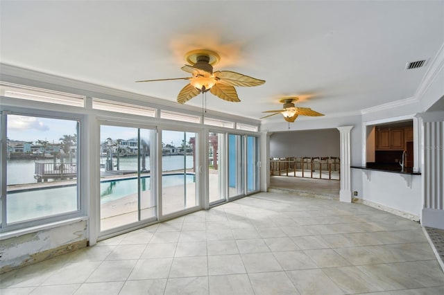 unfurnished sunroom with visible vents, a ceiling fan, and a water view