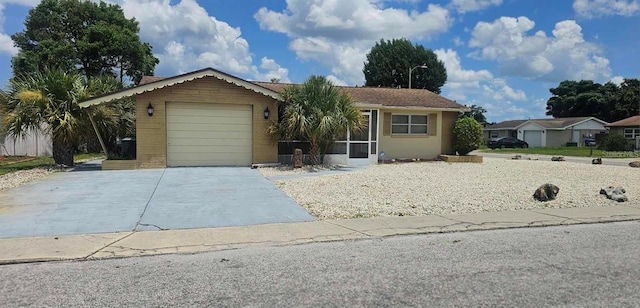 single story home featuring an attached garage and driveway