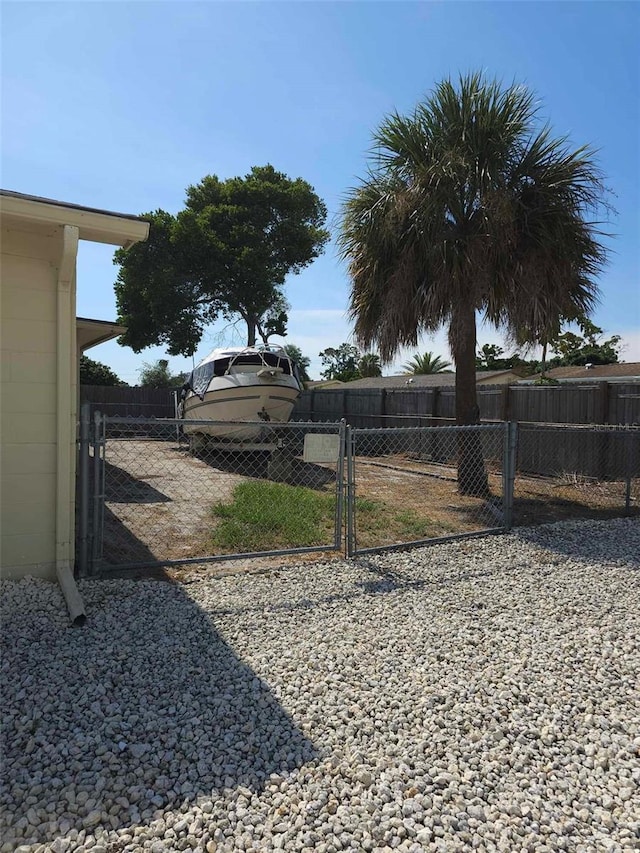 view of yard with fence and a gate