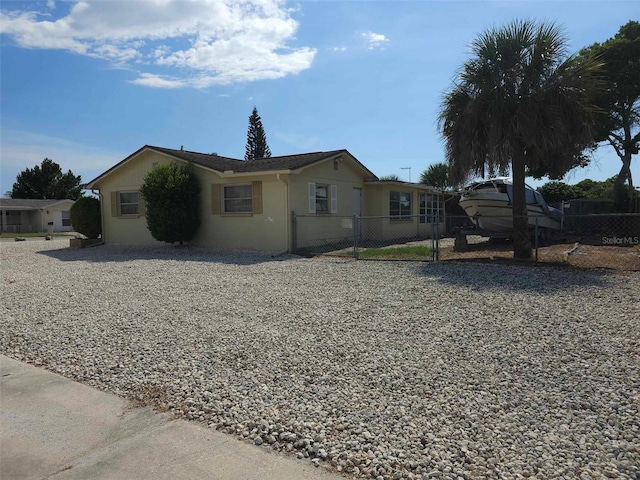 view of side of home featuring fence