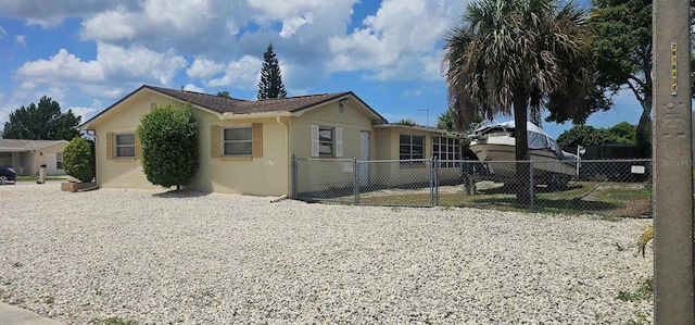 view of home's exterior featuring gravel driveway and fence