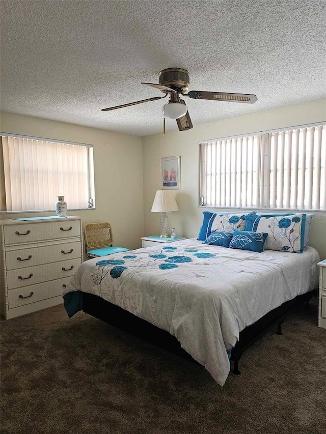 carpeted bedroom featuring a textured ceiling and a ceiling fan