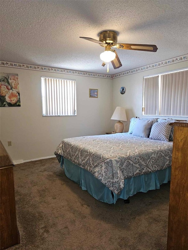 carpeted bedroom featuring a textured ceiling and ceiling fan