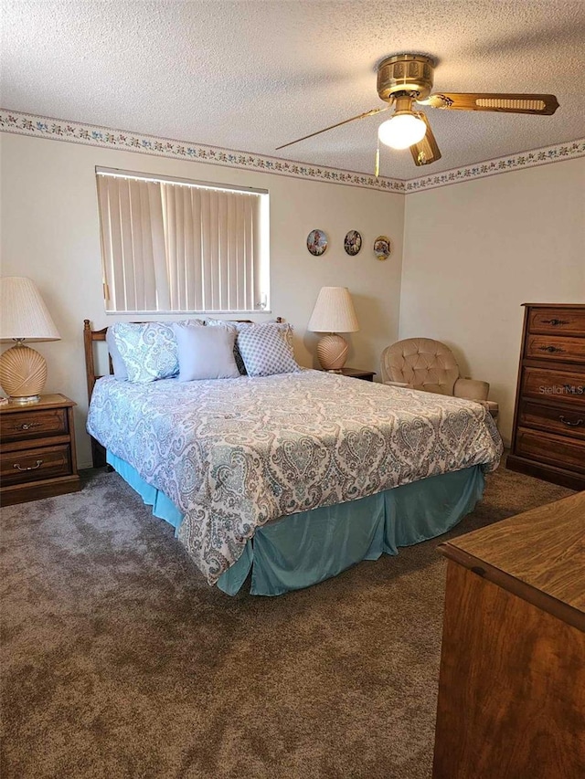 carpeted bedroom featuring a textured ceiling and ceiling fan