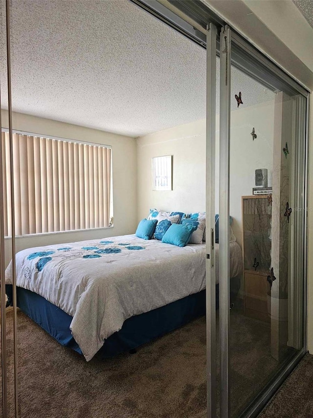 carpeted bedroom featuring a textured ceiling