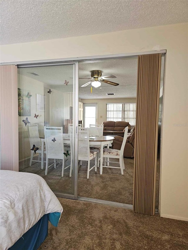 bedroom featuring carpet flooring, a closet, and a textured ceiling