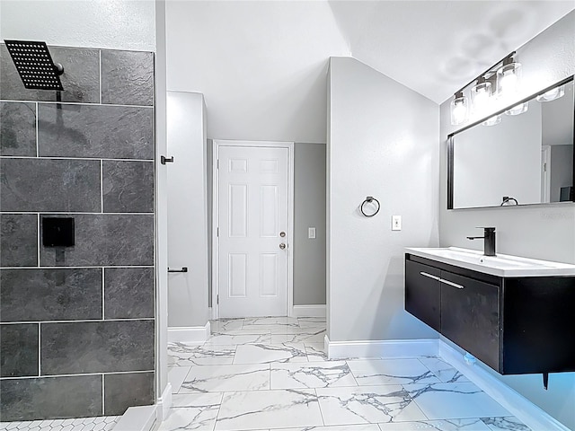 full bathroom featuring baseboards, tiled shower, marble finish floor, and vaulted ceiling