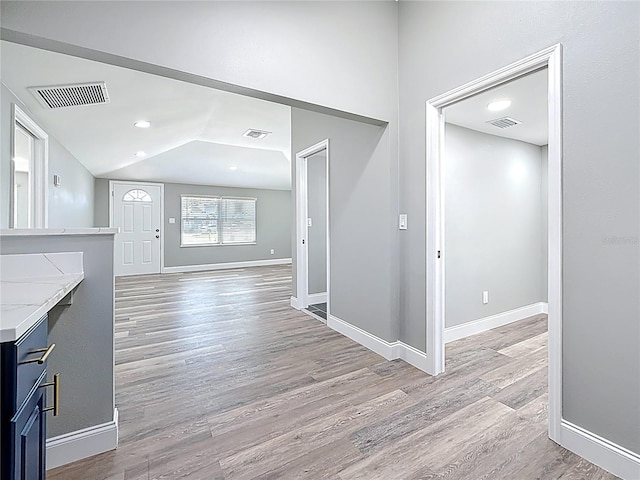 entrance foyer with visible vents, baseboards, and light wood-style floors