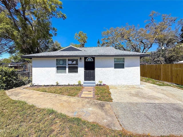 view of front of home featuring stucco siding and fence