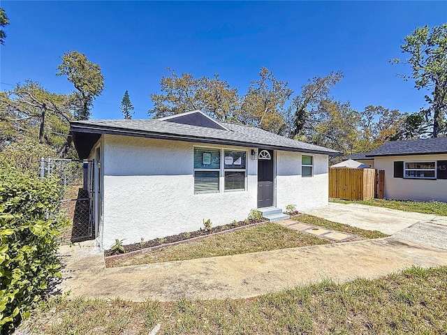 view of front of home featuring fence and stucco siding