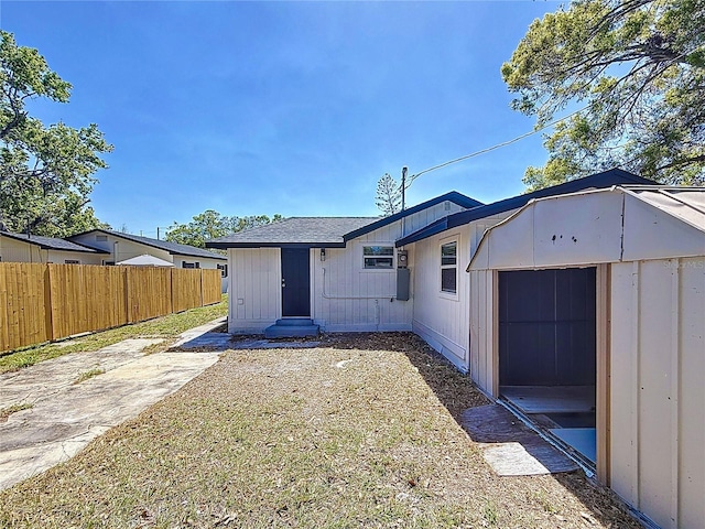 rear view of house with a patio area, entry steps, and fence