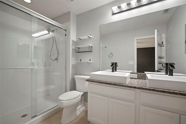 full bathroom featuring a sink, toilet, and a stall shower