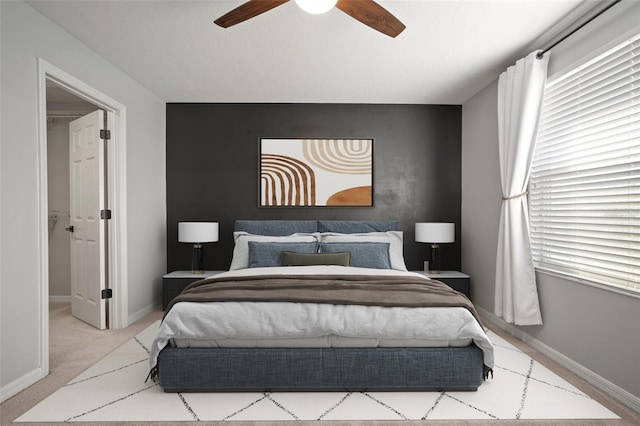 bedroom with carpet flooring, multiple windows, a ceiling fan, and baseboards