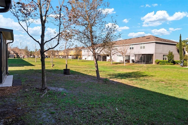 view of yard with a residential view and a sunroom