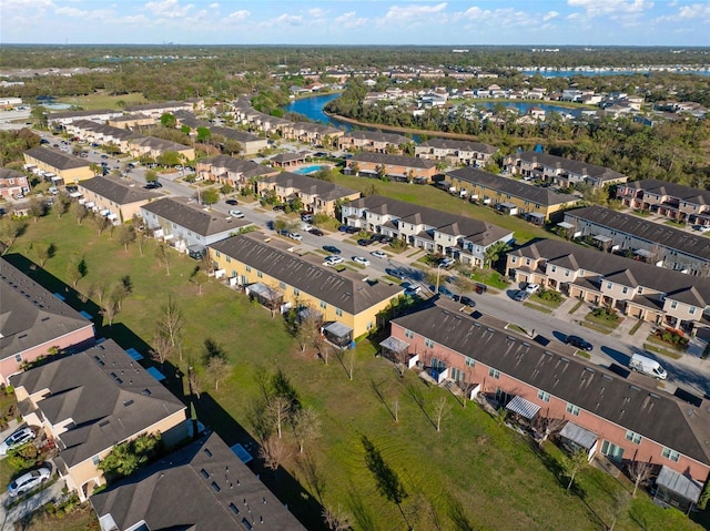 drone / aerial view with a residential view and a water view