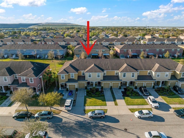 birds eye view of property with a residential view