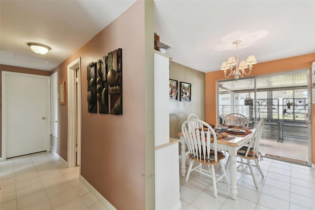 dining room with a chandelier, baseboards, and light tile patterned flooring