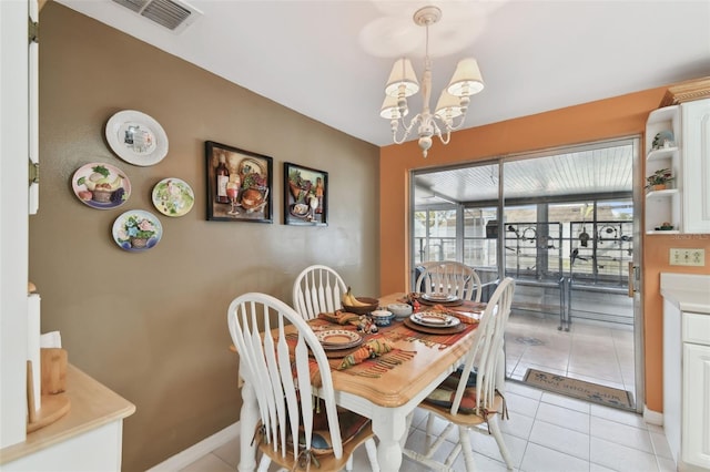 dining area featuring light tile patterned floors, visible vents, baseboards, and a chandelier