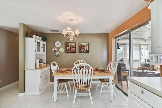 dining space with a chandelier, visible vents, baseboards, and light tile patterned floors