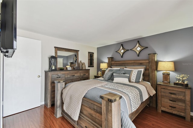 bedroom with baseboards and wood finished floors