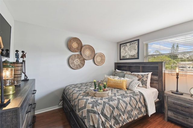 bedroom featuring baseboards and dark wood-style flooring