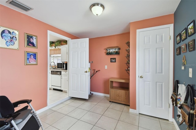 interior space with light tile patterned floors, baseboards, and visible vents