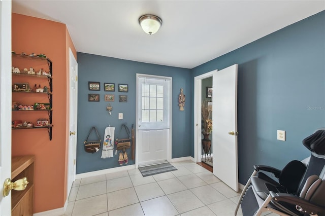 entrance foyer featuring light tile patterned floors and baseboards