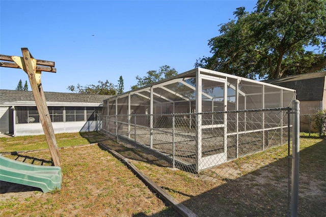 view of yard with glass enclosure