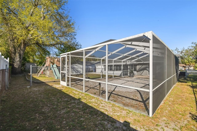 view of outdoor structure with a fenced backyard and a playground