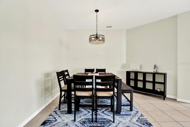 dining area with baseboards, light tile patterned floors, and visible vents
