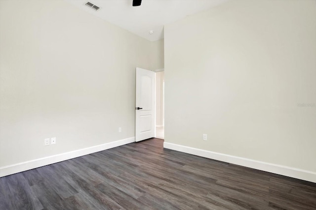 empty room with visible vents, a ceiling fan, baseboards, and dark wood-style flooring
