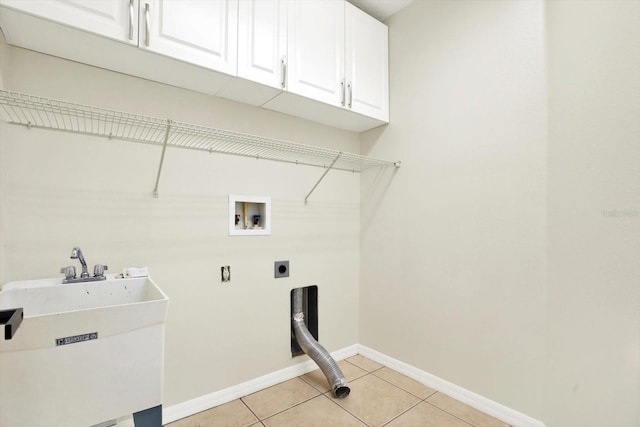 laundry room featuring cabinet space, washer hookup, a sink, electric dryer hookup, and baseboards