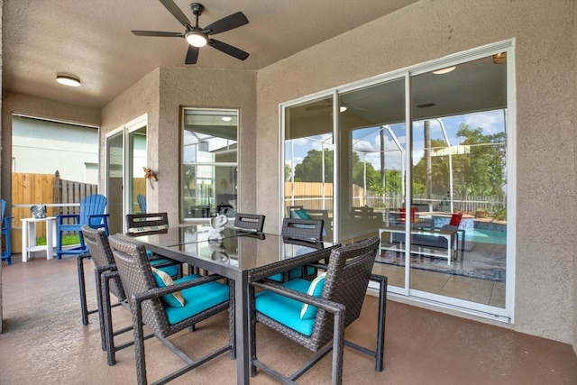 sunroom / solarium with a ceiling fan