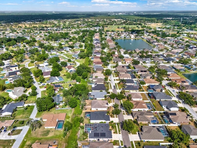 drone / aerial view featuring a water view and a residential view