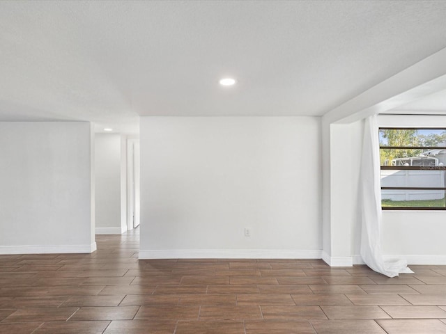 unfurnished room featuring recessed lighting, baseboards, and wood finish floors