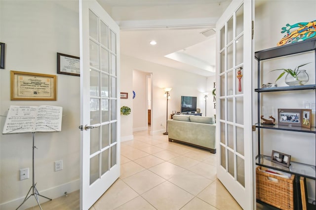 corridor featuring tile patterned flooring, recessed lighting, french doors, and baseboards