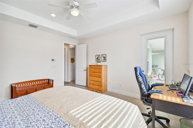 bedroom featuring a ceiling fan, baseboards, visible vents, light tile patterned flooring, and a raised ceiling