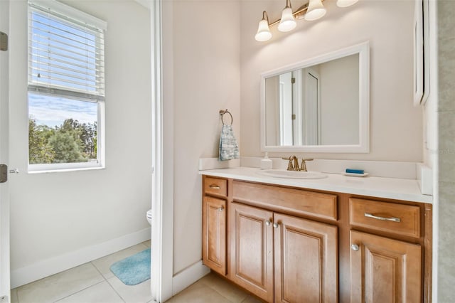 bathroom featuring baseboards, toilet, vanity, and tile patterned flooring